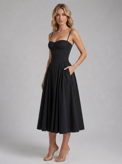 Beatrice Full Skirt Corset Midi Dress in Black - front view with hands in the side pockets