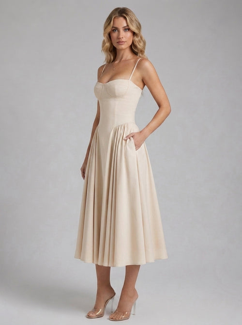 Beatrice Full Skirt Corset Midi Dress in Ivory - front view with hands in the side pockets