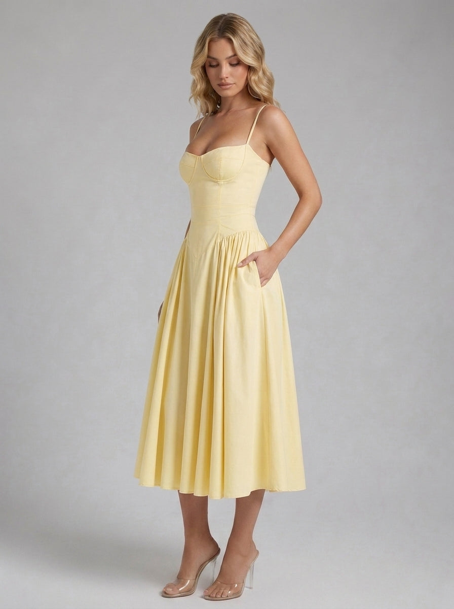 Beatrice Full Skirt Corset Midi Dress in Lemon - front view with hands in the side pockets
