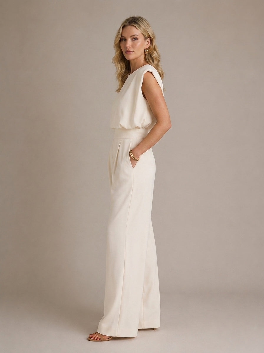 Charlotte Sleeveless Pleated Wide Leg Jumpsuit in Cream - side view showing the wide leg